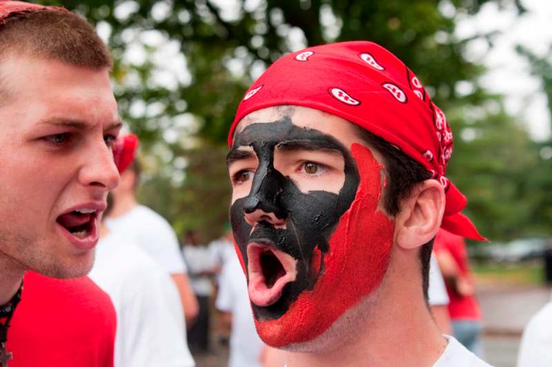 a man with face paint and red bandana