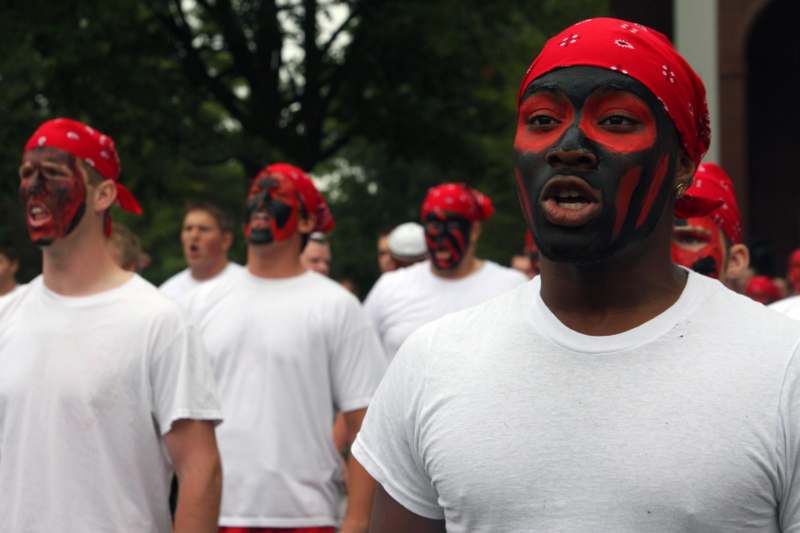 a man with red face paint and bandana