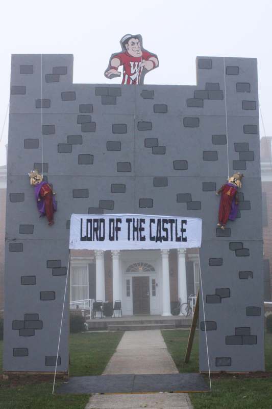 a large grey castle with a sign above it
