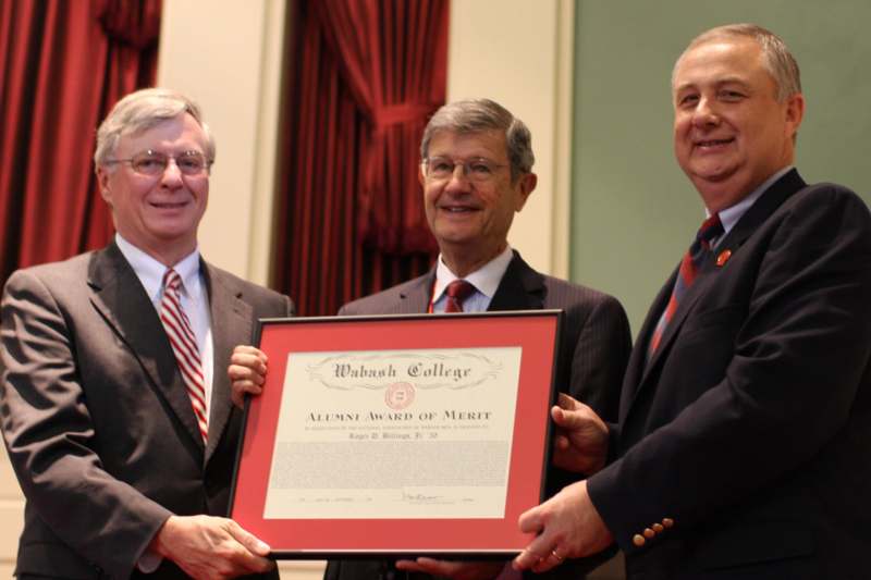 a group of men holding a diploma