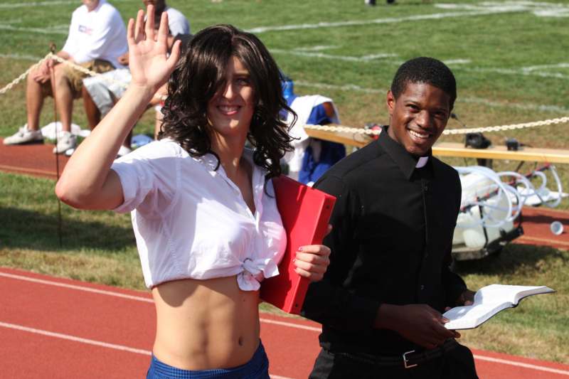 a man and woman waving at a sports event