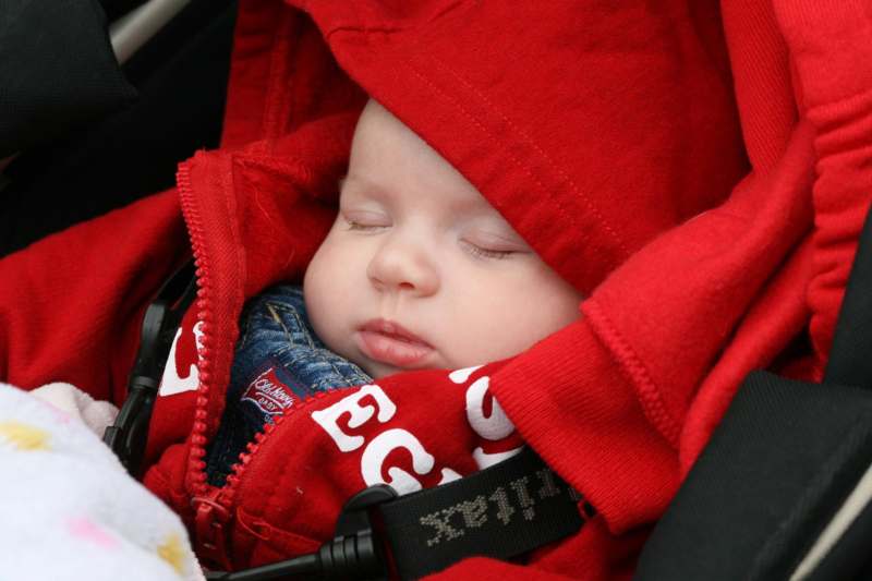 a baby sleeping in a car seat