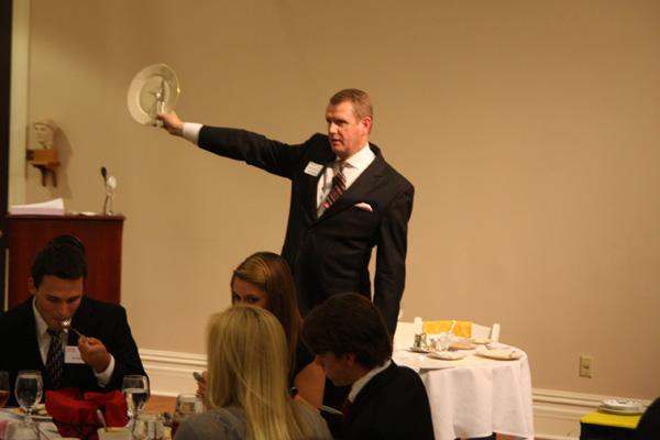 a man in a suit holding a plate