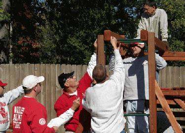 a group of people working on a wooden structure