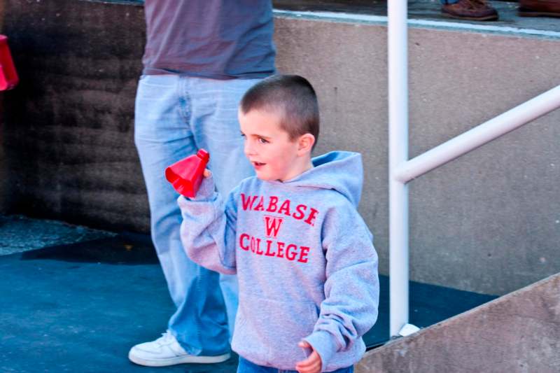 a boy holding a bell