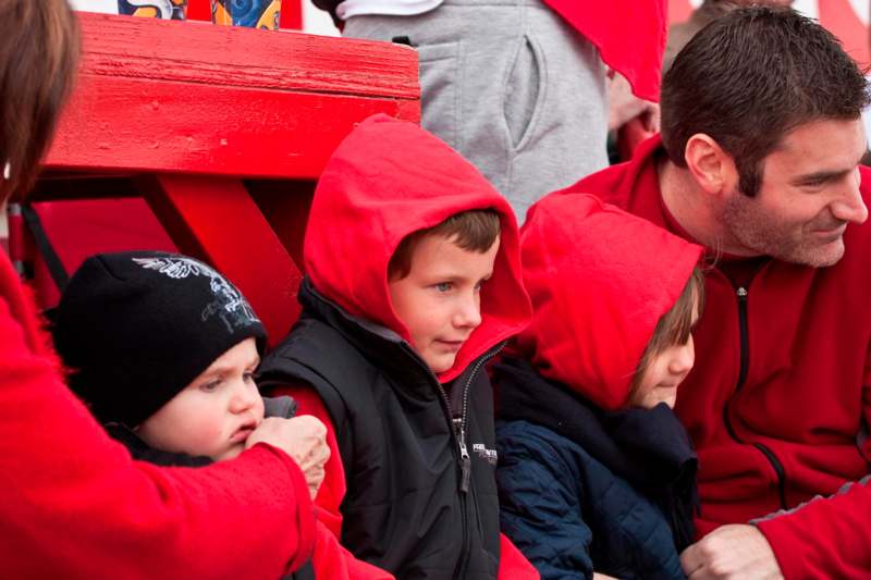 a group of children in red hoodies