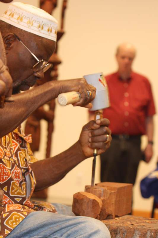 a man using a hammer to make a sculpture