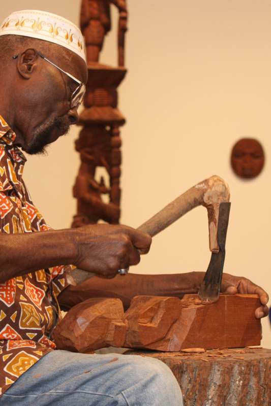 a man carving a wood carving