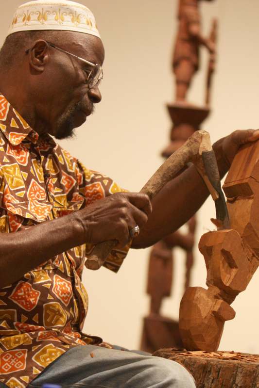 a man carving a statue