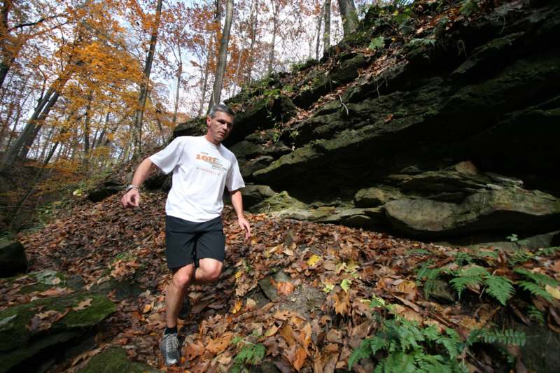 a man running on a rocky hillside