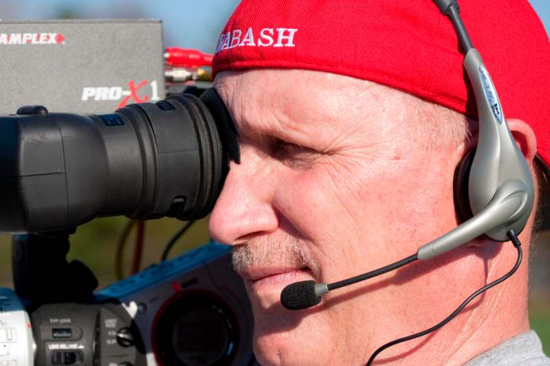 a man with a headset looking through a camera