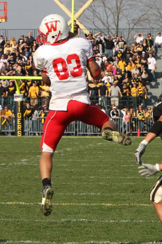 a football player in a red uniform jumping in the air