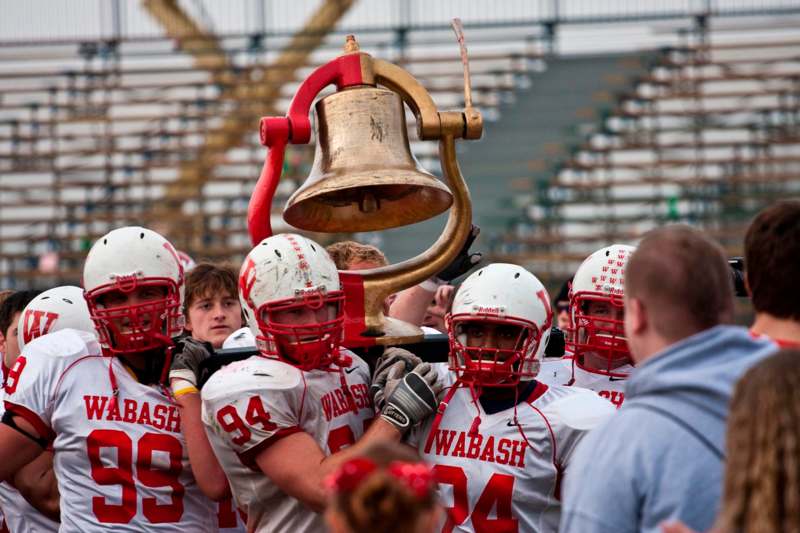 a football players holding a bell