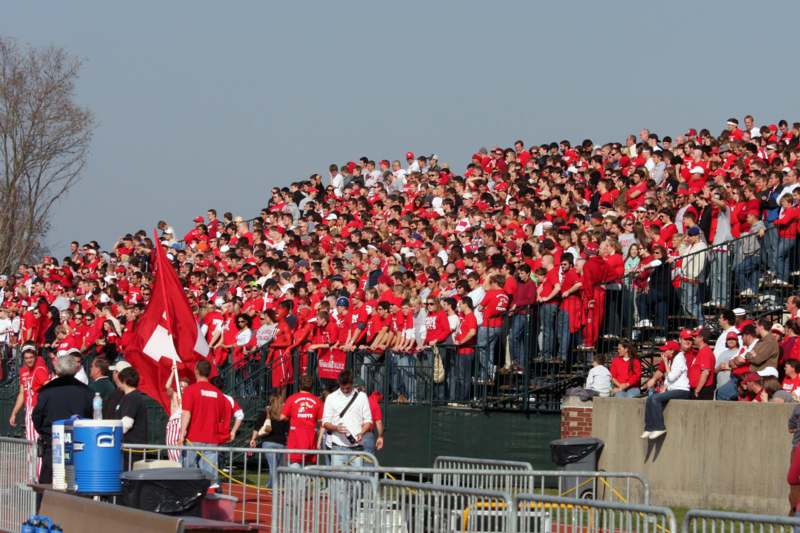 a large crowd of people in red shirts