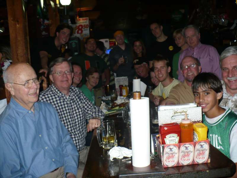 a group of people standing around a bar