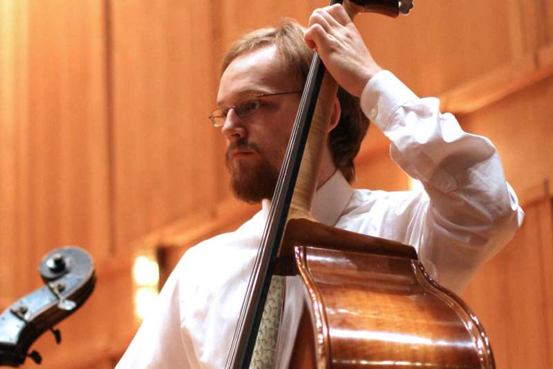 a man holding a cello