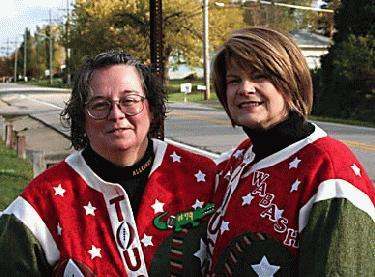 women wearing christmas sweaters and smiling