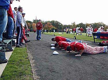 a group of people doing pushups on the ground