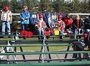 a group of people sitting on bleachers