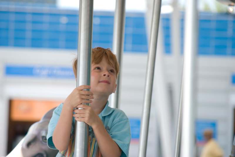 a young boy holding a pole