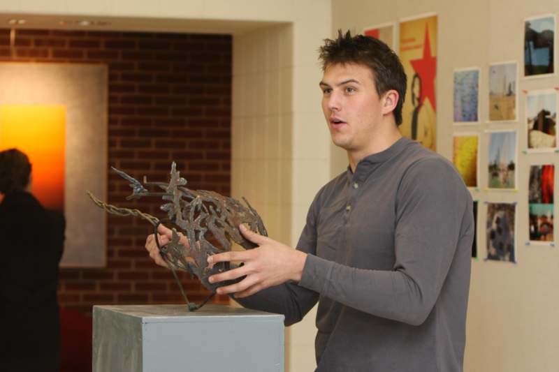 a man holding a sculpture