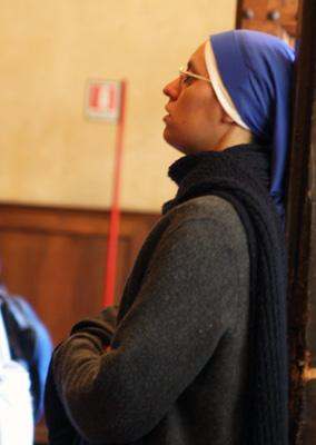 a woman wearing a blue scarf and a head wrap