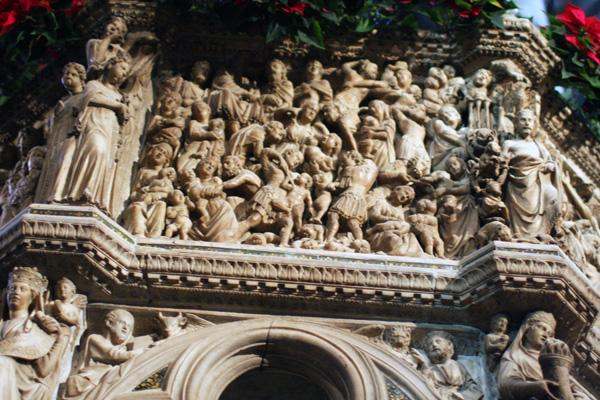 a stone carving of people on a building