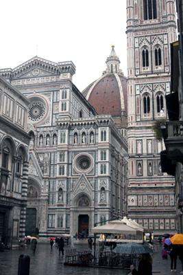 a large building with a dome with Florence Cathedral in the background