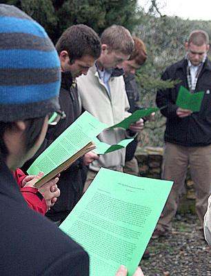 a group of people reading papers