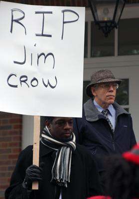 a group of men holding a sign