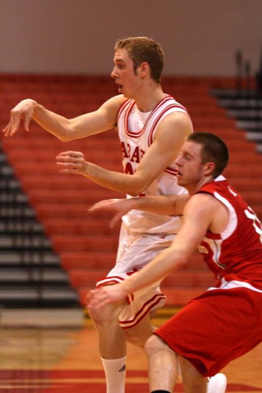 a basketball player in a red uniform playing basketball