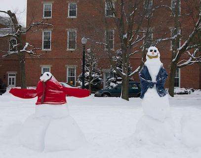 snowmen in a snowy yard
