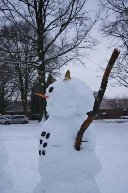 a snowman with a stick