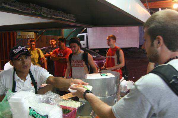 a man serving food to a group of people