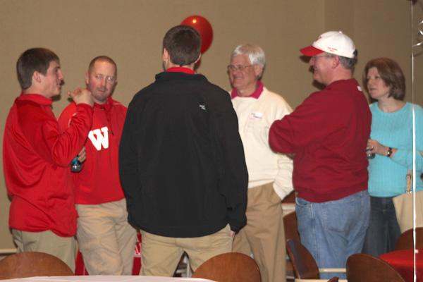 a group of men wearing red and white sweaters