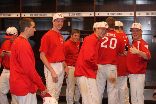 a group of baseball players in red shirts