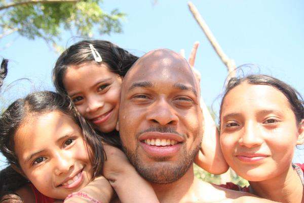 a man with two girls on his shoulders