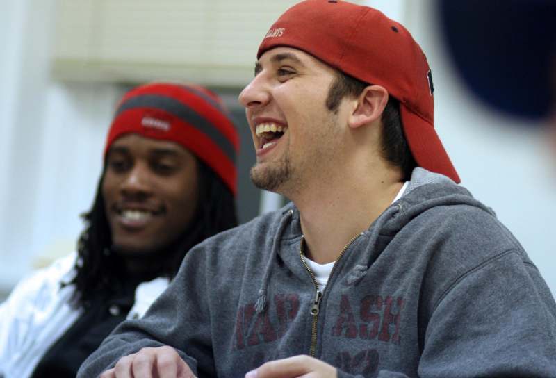 a man wearing a red hat laughing