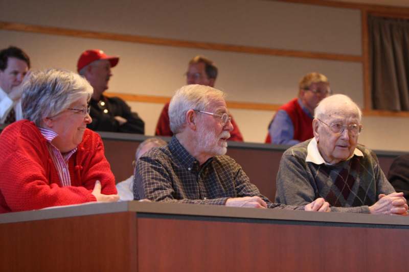 a group of old people sitting in a lecture hall