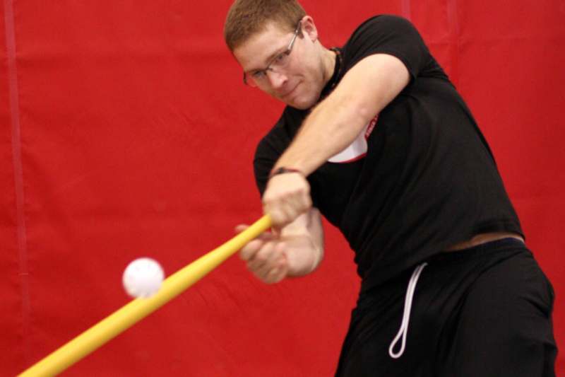 a man hitting a ball with a bat