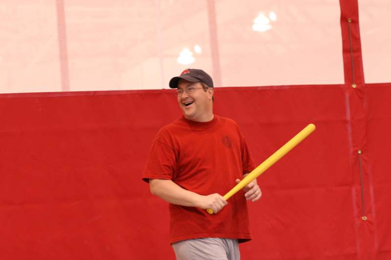 a man holding a yellow bat