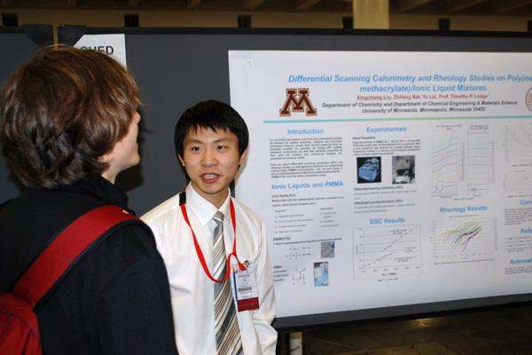 a young men looking at a poster