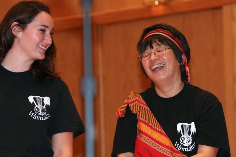 a woman laughing with another woman