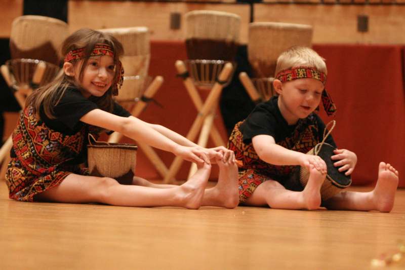 a boy and girl sitting on the floor