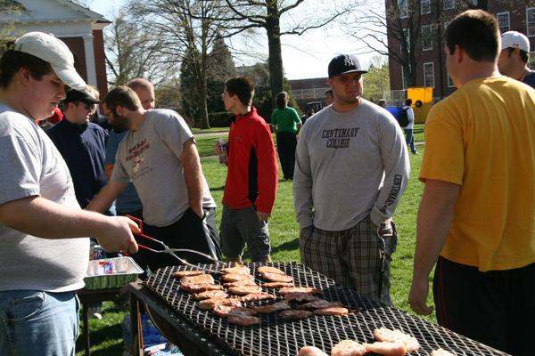 a group of people grilling meat