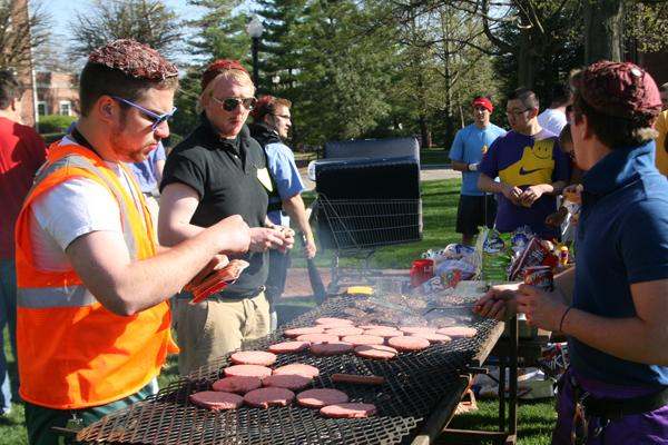 a group of people grilling hamburgers
