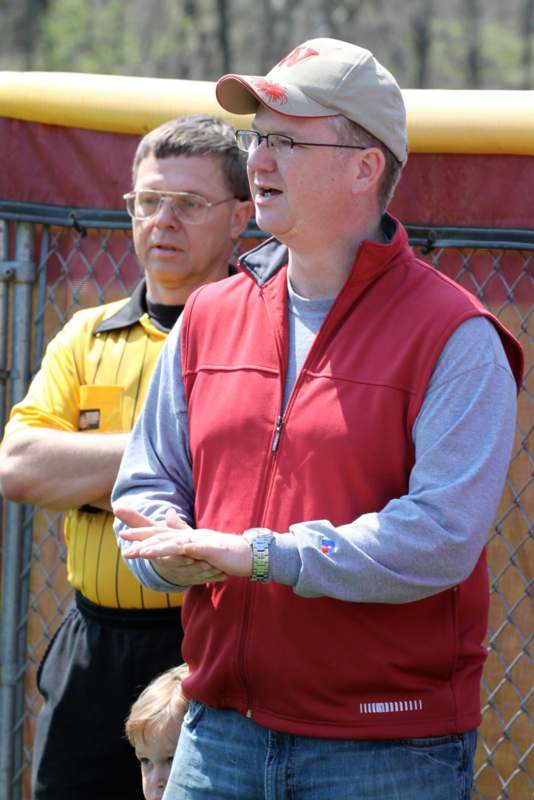 a man in a red vest and a cap