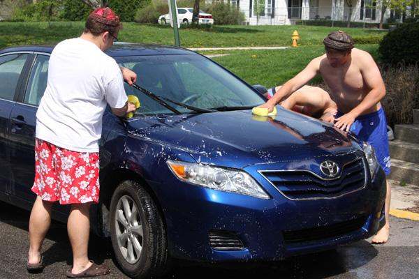 a group of men washing a car