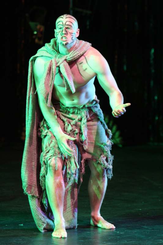 a man in garment dancing on stage