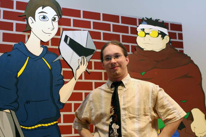 a man standing in front of a cartoon wall